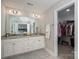 Double vanity bathroom with granite counters and access to a walk-in closet at 3017 Winged Teal Ct, Belmont, NC 28012