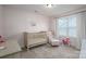Bedroom featuring neutral colors, a crib, and comfortable seating area at 3017 Winged Teal Ct, Belmont, NC 28012