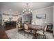 Elegant dining room featuring a wooden table with seating and stylish chandelier lighting at 3017 Winged Teal Ct, Belmont, NC 28012