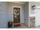 Close-up of a stylish front door with a decorative wreath and a welcoming 