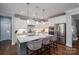 Well-equipped kitchen featuring stainless steel appliances, a large island, and stylish bar stools at 3017 Winged Teal Ct, Belmont, NC 28012