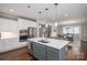 Open-concept kitchen featuring a large center island, stainless steel appliances, and a view of the dining area at 3017 Winged Teal Ct, Belmont, NC 28012