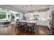 Modern kitchen with a spacious island, pendant lighting, and seamless flow into the living area at 3017 Winged Teal Ct, Belmont, NC 28012
