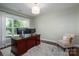 Bright home office with a large window, wooden desk setup, and cozy seating at 3017 Winged Teal Ct, Belmont, NC 28012