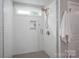 Bright white tiled shower with glass door and window at 3017 Winged Teal Ct, Belmont, NC 28012