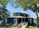 Inviting two-story home with a metal roof, landscaped yard, and water views at 31009 Executive Pt, Tega Cay, SC 29708