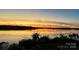 Breathtaking sunset view overlooking the tranquil waterfront, creating a serene and picturesque setting at 31009 Executive Pt, Tega Cay, SC 29708