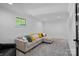 Finished basement with cozy seating area, plush carpet, and natural light from a window at 3209 Mayfield Ave # 11, Charlotte, NC 28209