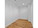 Empty basement room with clean white walls and light wood-look flooring at 3209 Mayfield Ave # 11, Charlotte, NC 28209