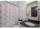 Charming bathroom with patterned shower curtain, stone countertop, and elegant mirror at 3209 Mayfield Ave # 11, Charlotte, NC 28209
