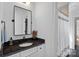 Stylish bathroom with a black framed mirror, dark countertop, and modern fixtures creating a sleek, contemporary design at 3209 Mayfield Ave # 11, Charlotte, NC 28209