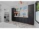 Modern bathroom with dual vanities, black cabinetry, marble countertops, pendant lighting, and stylish herringbone floors at 3209 Mayfield Ave # 11, Charlotte, NC 28209