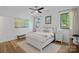 Bright bedroom features a bed, bench, and stylish decor, creating a relaxing atmosphere at 3209 Mayfield Ave # 11, Charlotte, NC 28209