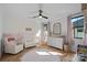 Sunlit Bedroom features a white crib, changing table, round rug, and soft color palette at 3209 Mayfield Ave # 11, Charlotte, NC 28209