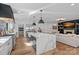 Open-concept kitchen featuring an oversized island, stainless steel appliances, and fireplace views at 3209 Mayfield Ave # 11, Charlotte, NC 28209