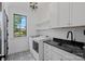 Bright laundry room with modern appliances, ample counter space, stylish cabinets, and a charming patterned floor at 3209 Mayfield Ave # 11, Charlotte, NC 28209