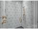 Detailed shower stall with geometric tile and gold fixtures for a luxurious feel at 3209 Mayfield Ave # 11, Charlotte, NC 28209