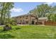 Spacious backyard featuring a well-manicured lawn, patio, and outdoor dining area at 323 Richmond Rd, Salisbury, NC 28144