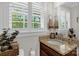 Bright bathroom with granite countertop, classic fixtures, white shutters, and natural light at 323 Richmond Rd, Salisbury, NC 28144