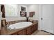 Luxurious bathroom with large soaking tub and wood accents at 323 Richmond Rd, Salisbury, NC 28144
