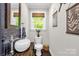 Charming powder room featuring a stylish vessel sink, wood countertop and decorative blue tile backsplash at 323 Richmond Rd, Salisbury, NC 28144
