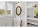 Quaint bathroom featuring sink with decorative tile backsplash and a window with shutters at 323 Richmond Rd, Salisbury, NC 28144