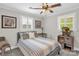 Bedroom featuring a ceiling fan, neutral color scheme and light from shuttered windows at 323 Richmond Rd, Salisbury, NC 28144