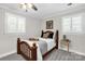 Cozy bedroom with a wood-frame bed and natural light from shuttered windows at 323 Richmond Rd, Salisbury, NC 28144