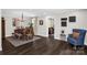 Open-concept dining room with hardwood floors and a blue accent chair at 323 Richmond Rd, Salisbury, NC 28144