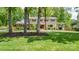 Charming two-story home with mature trees, stone accents, shutters, and a manicured lawn at 323 Richmond Rd, Salisbury, NC 28144