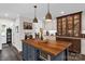 Bright kitchen featuring an island with seating, stainless appliances, and neutral custom cabinets at 323 Richmond Rd, Salisbury, NC 28144