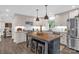Bright kitchen featuring an island with seating, stainless appliances, and neutral custom cabinets at 323 Richmond Rd, Salisbury, NC 28144