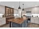 Bright kitchen with island, pendant lights, stainless appliances, granite countertops, and custom cabinetry at 323 Richmond Rd, Salisbury, NC 28144