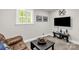 Relaxing living room with a leather couch, modern TV, and bright window at 323 Richmond Rd, Salisbury, NC 28144