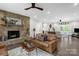 Bright living room with a stone fireplace, ceiling fan, and hardwood floors at 323 Richmond Rd, Salisbury, NC 28144