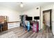 Bedroom featuring wood-look flooring, a ceiling fan, and an organized closet at 3726 Park Rd, Charlotte, NC 28209