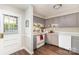 Galley kitchen with gray cabinets, modern flooring, and an exterior door at 3726 Park Rd, Charlotte, NC 28209