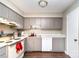 Traditional kitchen featuring gray cabinets, white appliances, and solid surface countertops at 3726 Park Rd, Charlotte, NC 28209