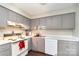 Traditional kitchen featuring gray cabinets, white appliances, and solid surface countertops at 3726 Park Rd, Charlotte, NC 28209