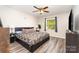 Comfortable main bedroom with a platform bed, wood-look flooring and natural light at 3726 Park Rd, Charlotte, NC 28209