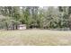 Large backyard featuring a storage shed and surrounding trees at 3816 Redman Rd, Shelby, NC 28150