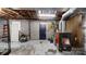 Unfinished basement with concrete walls, exposed pipes, and a wood-burning furnace at 3816 Redman Rd, Shelby, NC 28150