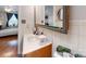Bathroom with a wood vanity, mirror with a green trim, and a view of a bedroom at 3816 Redman Rd, Shelby, NC 28150