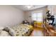 Comfortable bedroom with a sunflower-themed comforter, hardwood floors, and a window with blinds at 3816 Redman Rd, Shelby, NC 28150