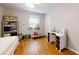 Well-lit bedroom with wood floors, a desk, a chair, and a closet at 3816 Redman Rd, Shelby, NC 28150