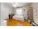Bright bedroom with wood floors, a window, a white bed, and a closet at 3816 Redman Rd, Shelby, NC 28150