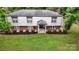Inviting home exterior with a lush lawn, manicured bushes, and cheerful blue chairs at 3816 Redman Rd, Shelby, NC 28150