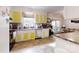 Bright kitchen featuring white cabinets with yellow accents, stainless steel appliances, and tile flooring at 3816 Redman Rd, Shelby, NC 28150