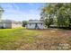 Backyard with a grass lawn and a house with gray siding at 403 Broad St, Kannapolis, NC 28081