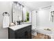 Bathroom with shower-tub combo, dark vanity, and natural light at 403 Broad St, Kannapolis, NC 28081